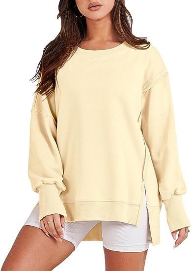 Cream-colored solid oversized sweatshirt crew with relaxed fit and side slits featuring a crew neck design.