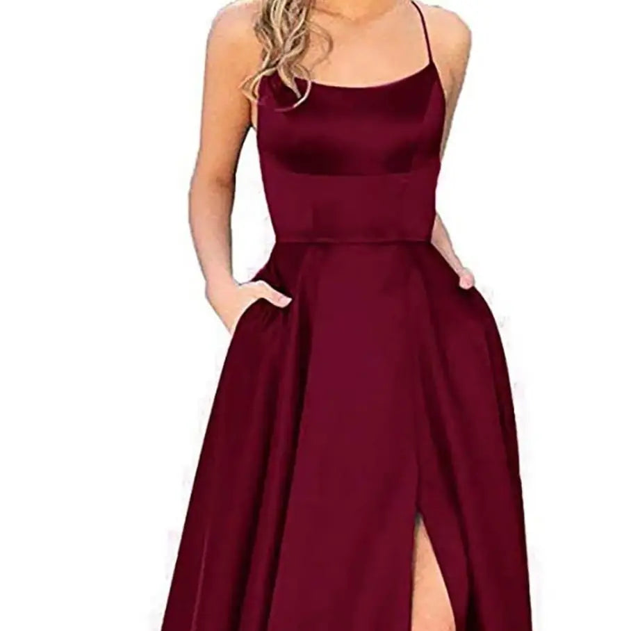 a solid color long slimming purple satin evening gown featuring a flowing burgundy fabric with thin spaghetti straps and a high slit designed for elegant occasions.