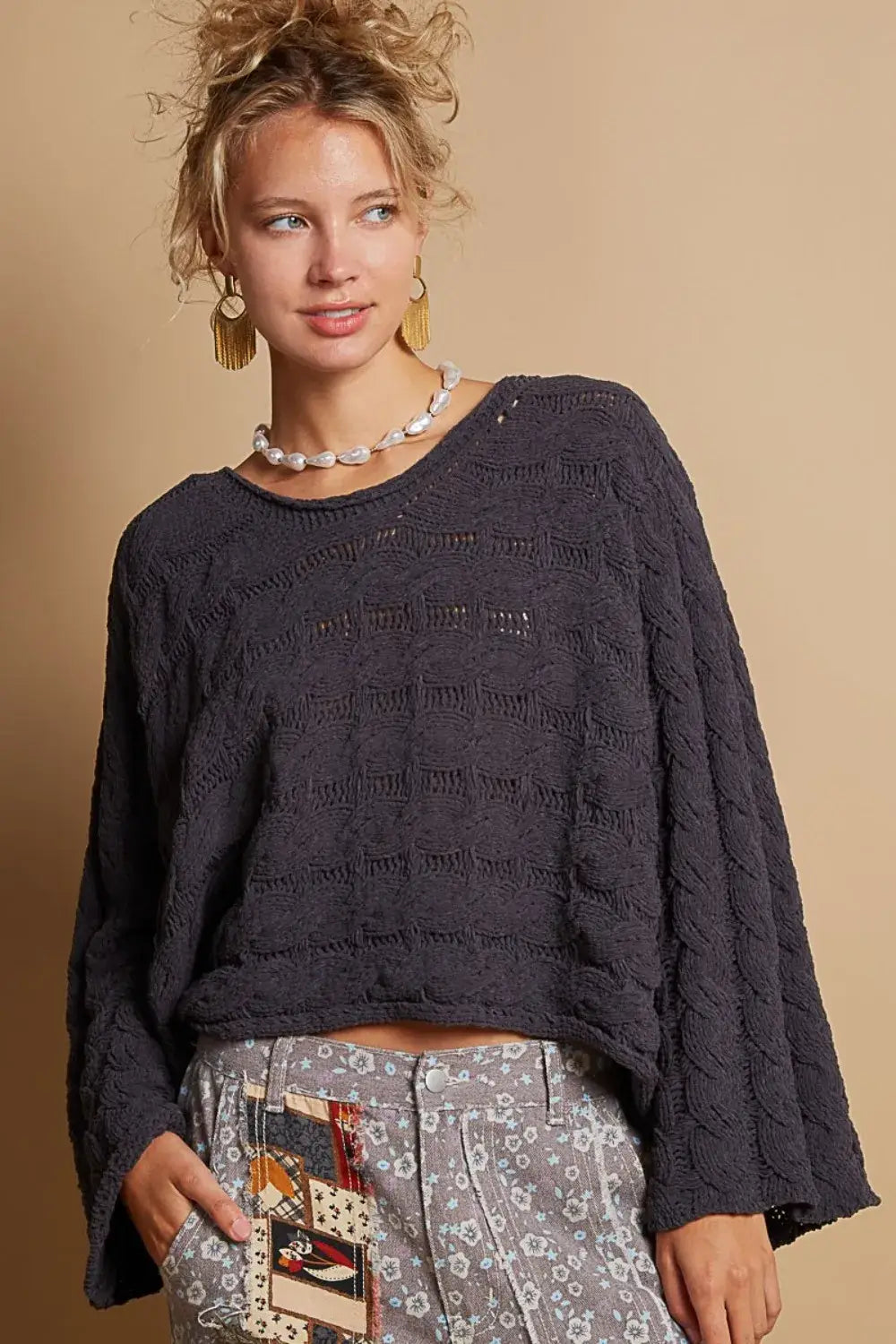 dark gray textured knit pol round neck cable knit cropped sweater with relaxed fit and detailed cable knit patterns