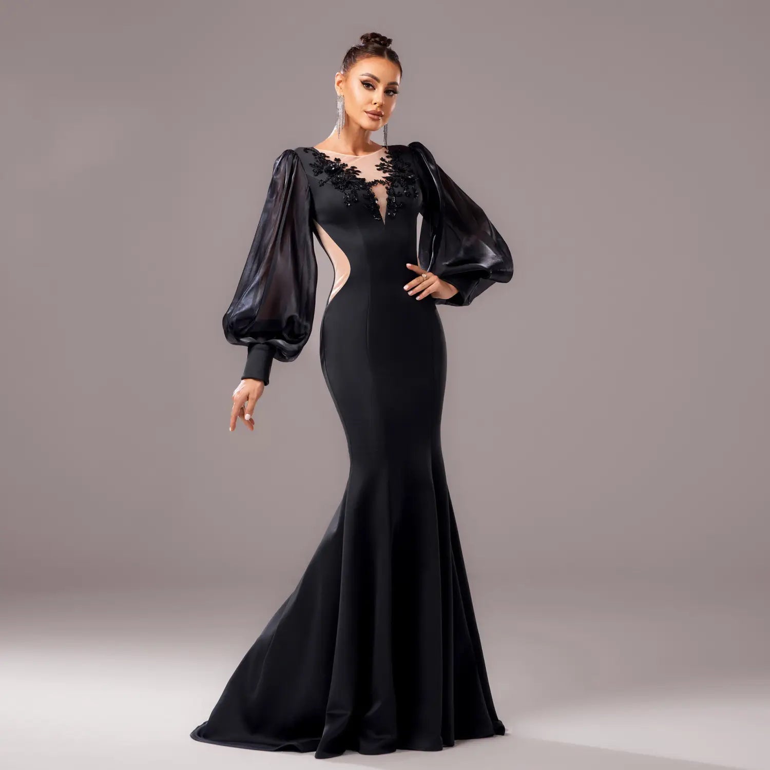Elegant black beaded long sleeve round neck fishtail gown featuring sheer puffy sleeves and intricate lace detailing at the neckline.