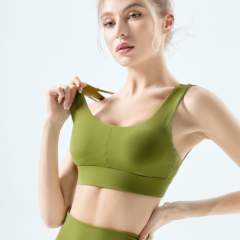 Olive green seamless fitness bra with wide supportive band and adjustable straps made from nylon main fabric.