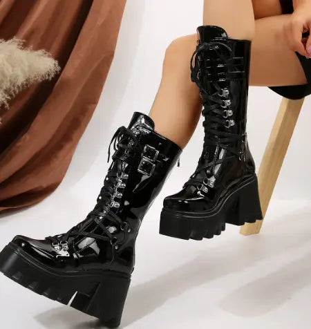 black versatile casual leather platform boots featuring black patent leather lace-up design with chunky platform soles and silver buckle accents.