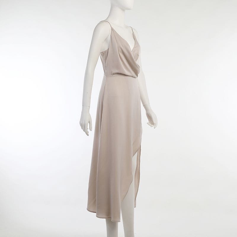 a flowing beige silk slip dress with a draped v-neckline and asymmetrical hem, perfect for dress summer fashion and featuring the elegance of a slit sling dress.