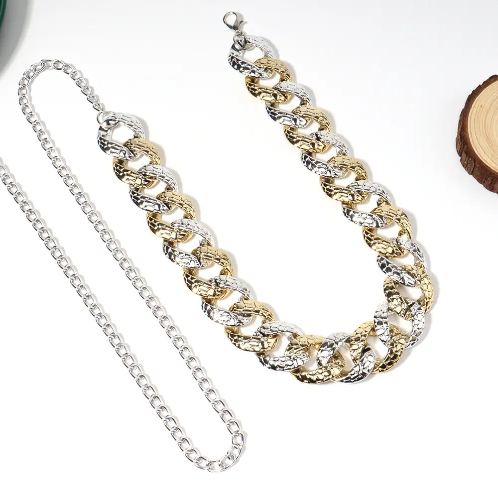 Two tone gold and silver chain summer body jewelry belt with textured interlocking links designed for jewelry summer looks.