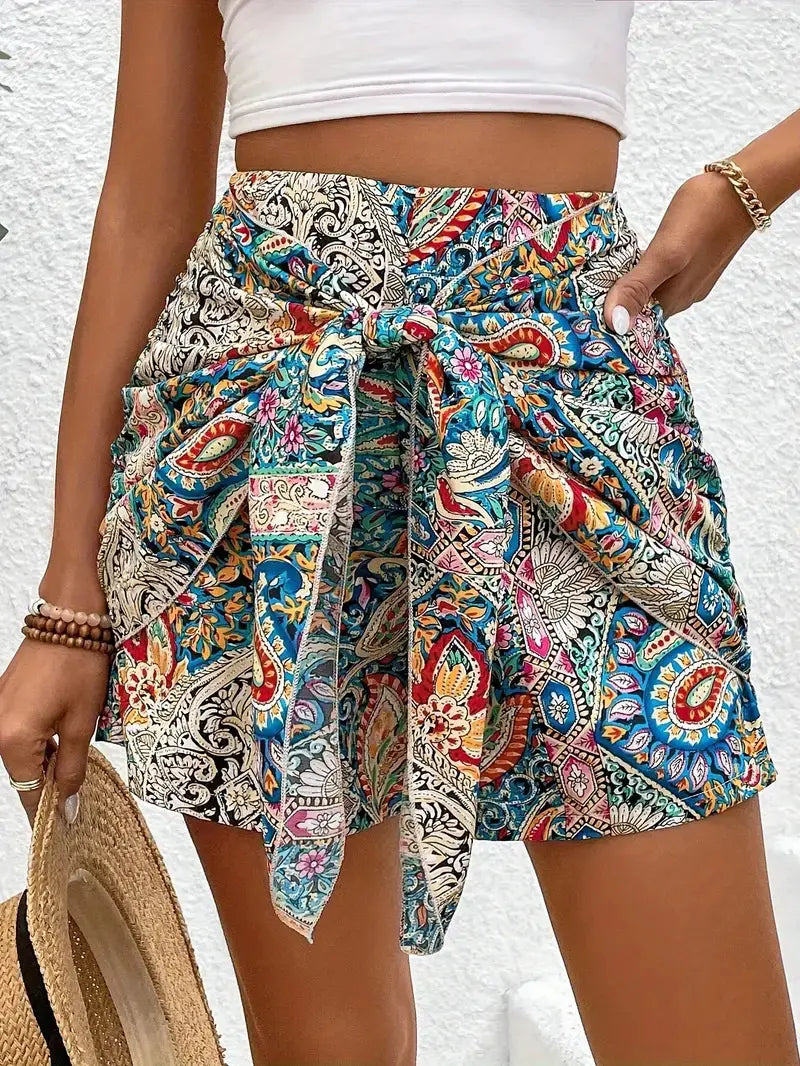 Colorful paisley-patterned slimming lace up printed irregular skirt shorts featuring a vibrant mix of blue, red, and gold tones.