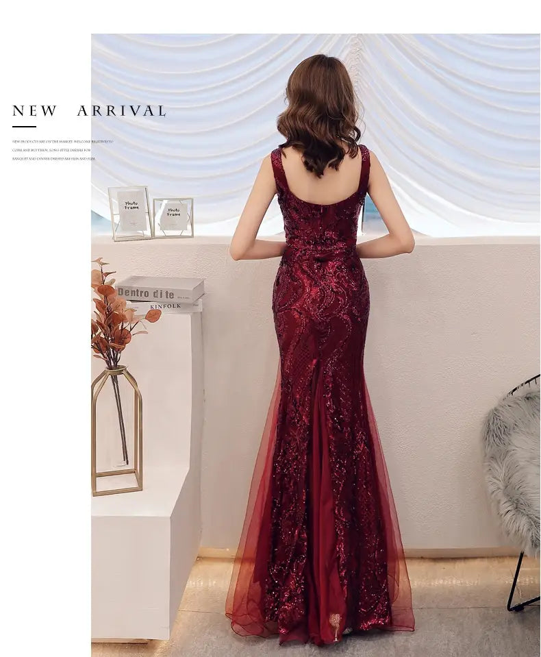 A shimmering burgundy fishtail long summer gown featuring intricate lace detailing and a fitted silhouette with summer sequins sling straps.