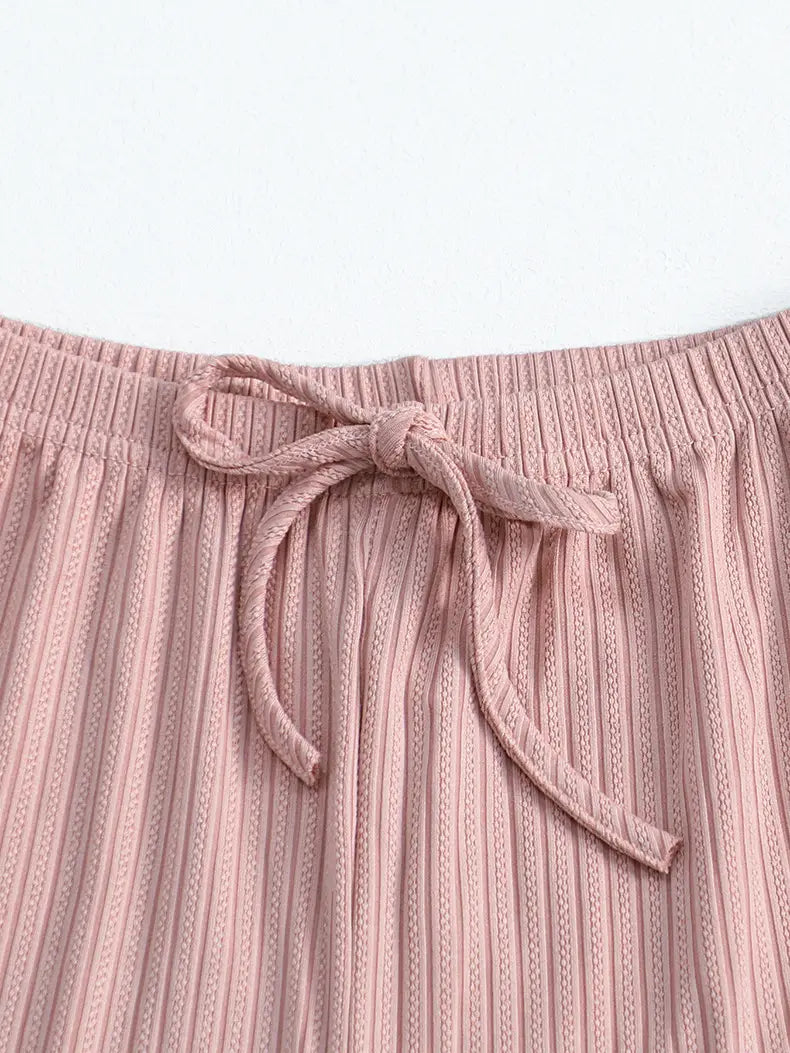 pink ribbed knit pants with a matching drawstring waistband complement the black ribbed lace ruffle sleeve pajama set for comfortable and stylish loungewear.