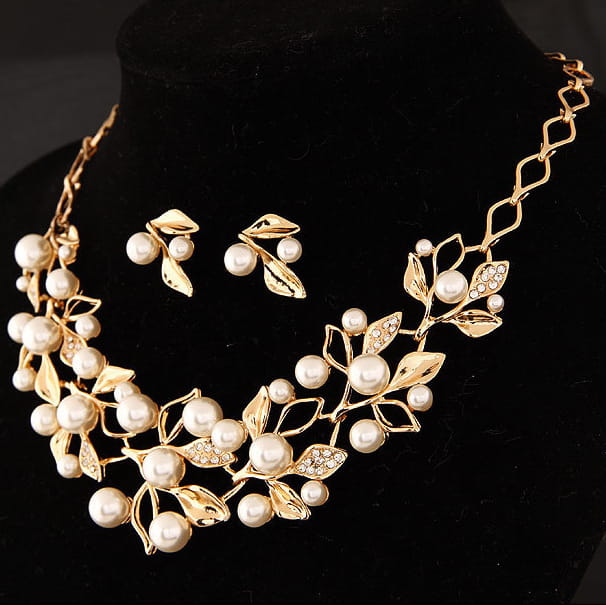 Gold-toned clover necklace jewelry with faux pearls and crystal accents paired with matching jewelry accessories earrings featuring pearl details.