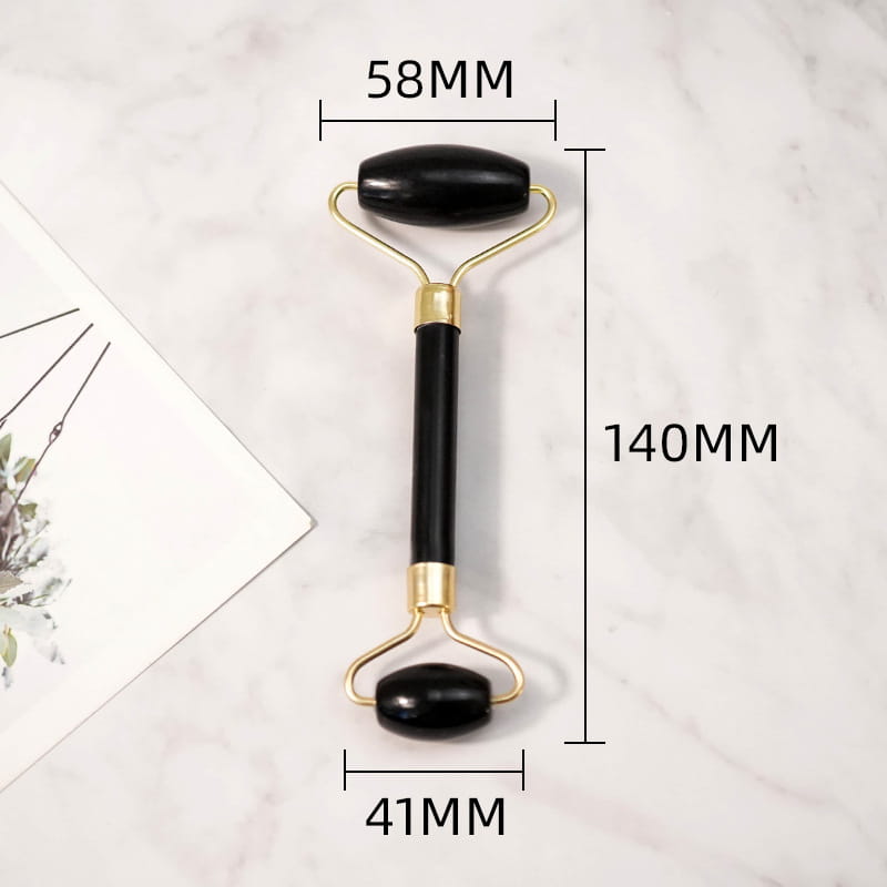 Black obsidian beauty face care face care massage jade roller with black onyx jade stones and gold-toned metal handles featuring a sleek polished finish.