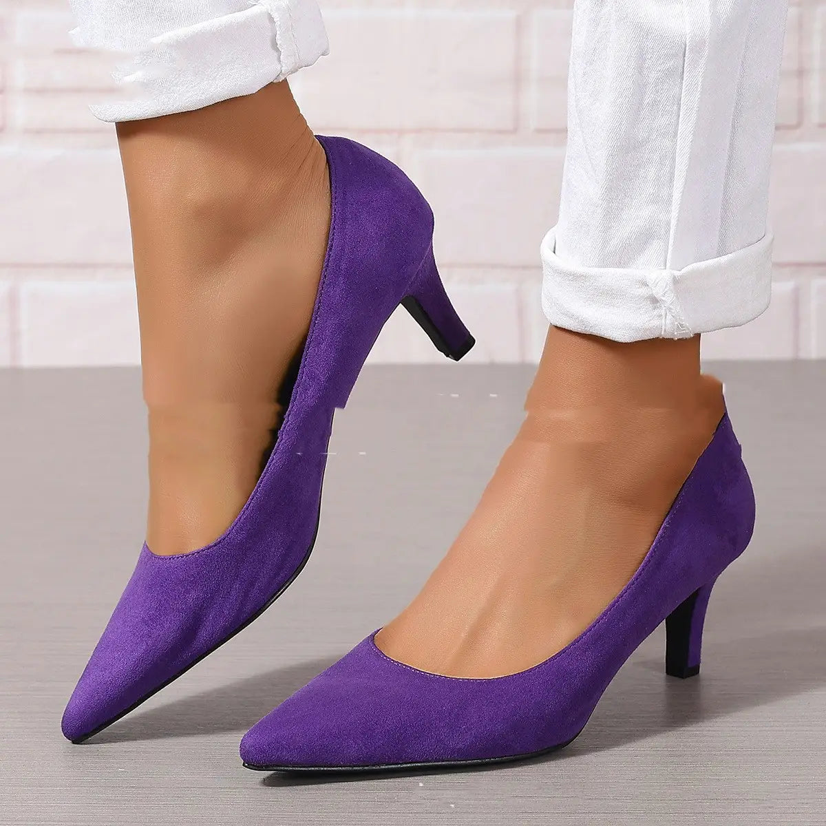 Purple suede pointed toe ladies stiletto heel pumps with a black stiletto heel for fashion ladies stiletto style.