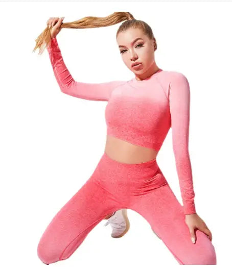 Women’s seamless gradient long sleeve crop top and matching leggings set in pink designed for yoga and activewear.