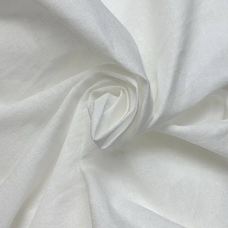 a soft off-white cotton fabric with a subtle sheen and gentle folds used in a white cotton linen slimming large hem midi skirt