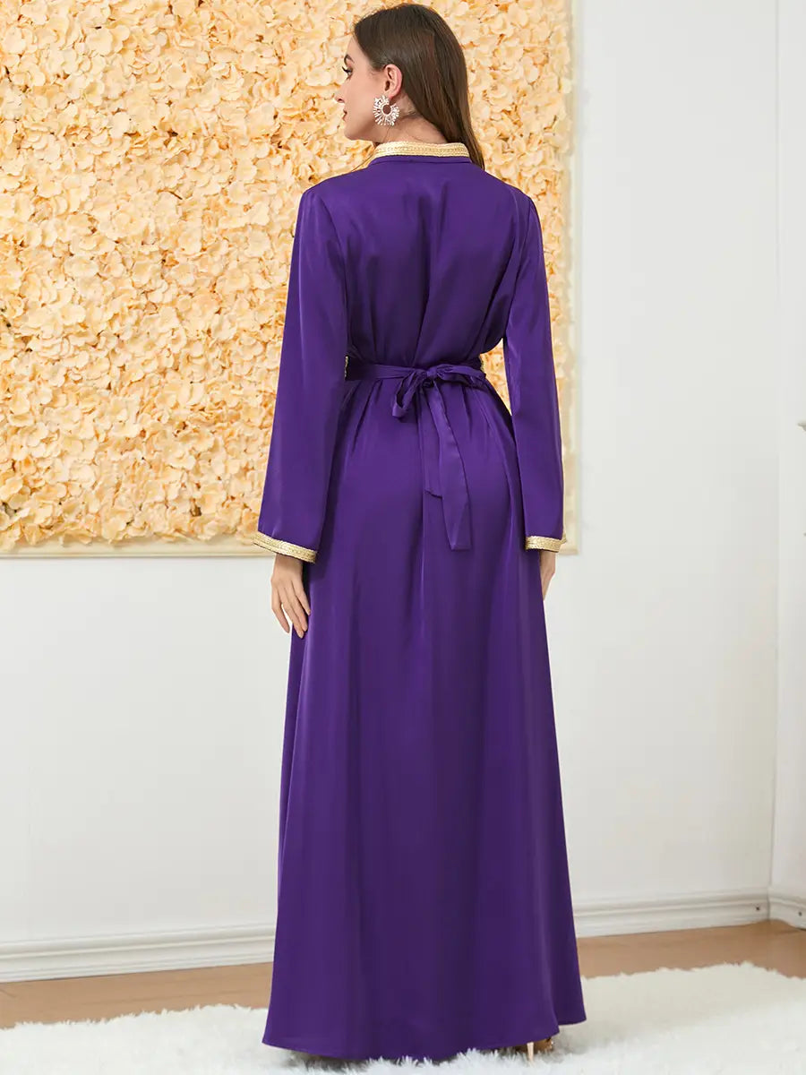 a flowing purple satin robe with gold-trimmed cuffs and collar tied at the waist with a matching belt featured as an embroidered long sleeve foreign trade dress