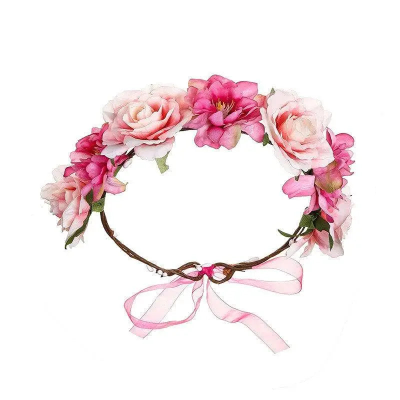 A delicate fabric colorful rose flower garland hair accessory with pink and white artificial roses and a sheer ribbon bow