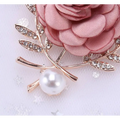A delicate fabric flower lady temperamental pin featuring a pink satin rose and rhinestone floral brooch set accents