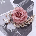 A delicate fabric flower lady temperamental pin with soft pink petals gold-toned floral brooch set with pearl accent