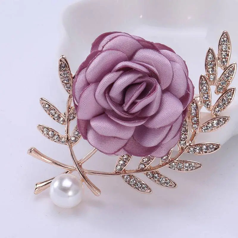 A delicate lavender satin fabric flower lady temperamental pin with rhinestone leaves and pearl in a floral brooch set