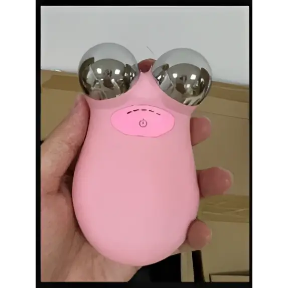 Pink handheld facial lifting firming roller with two silver spherical rollers and central pink button for skin rejuvenation