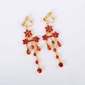Elegant red crystal chandelier earrings with gold-tone hooks complement a factory direct bride wedding dress diamond choker