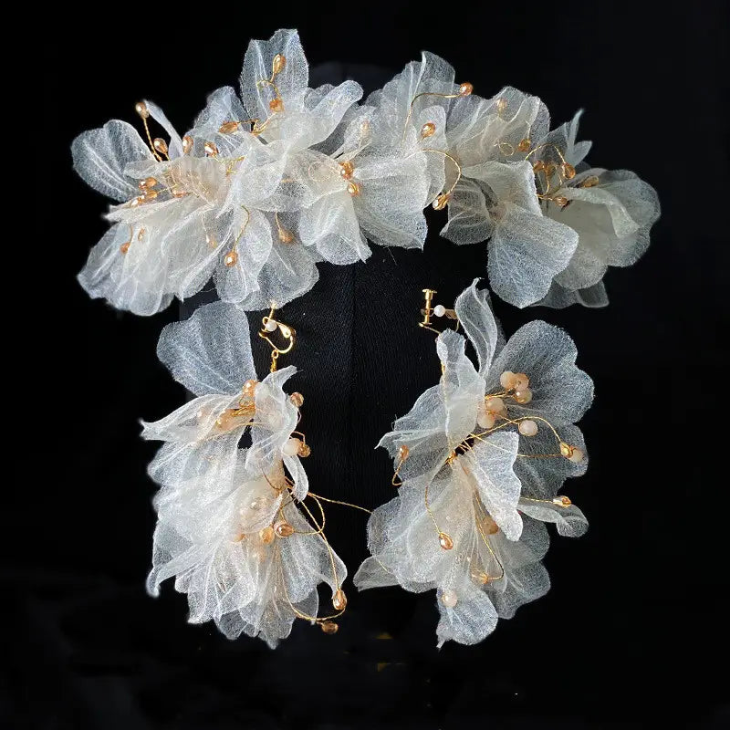Delicate white organza tulle flower headband earring set adorned with gold-toned beads and wire detailing.