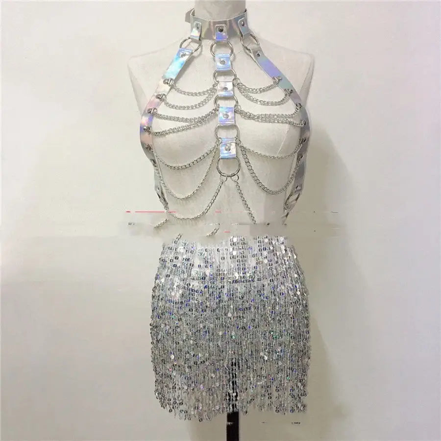 silver holographic chain harness top paired with a pink sequined fringe skirt for a night club stage dress woman ensemble.