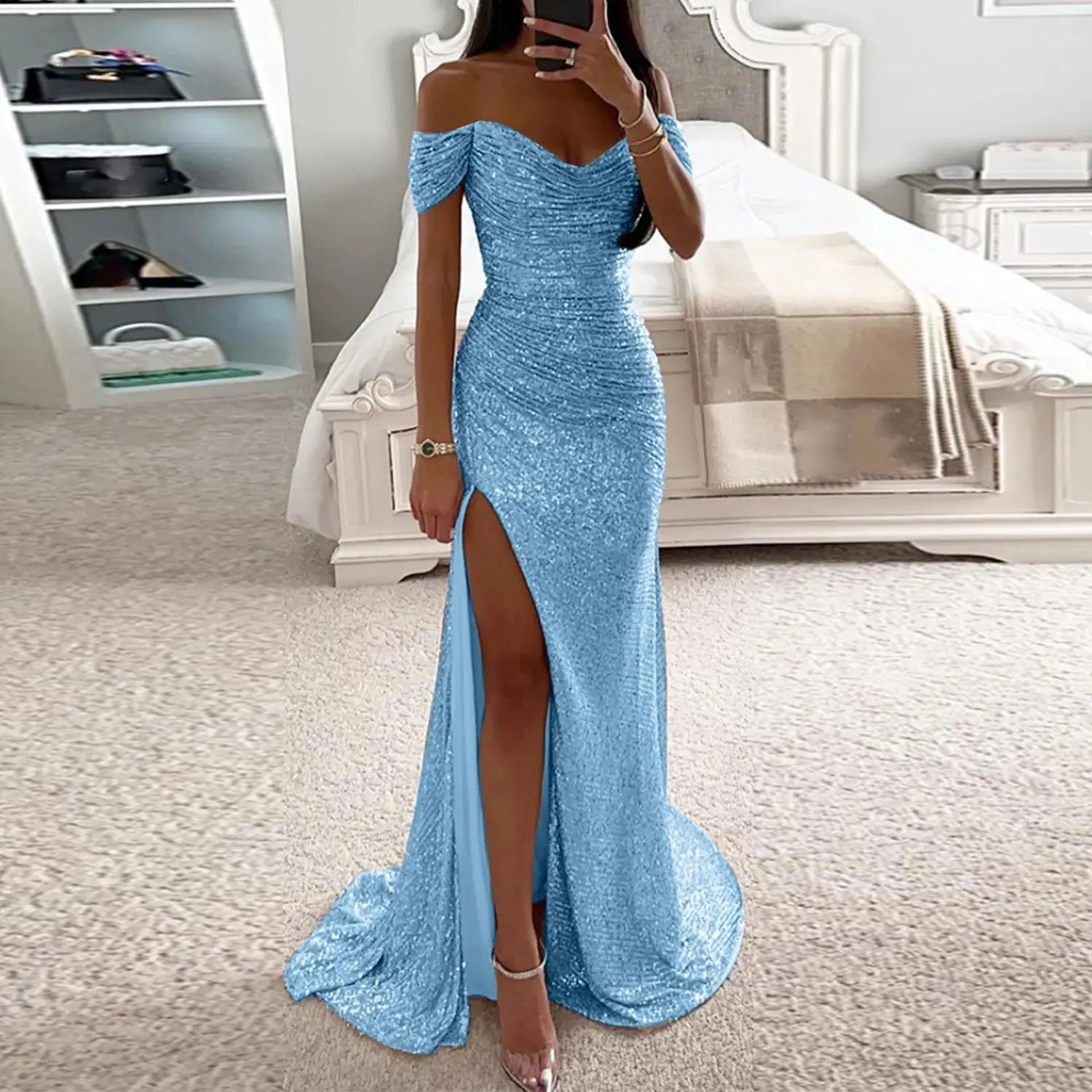 A shimmering light blue sequined off-the-shoulder gown with a high slit and fitted silhouette showcasing a female creative solid color sparkling design.