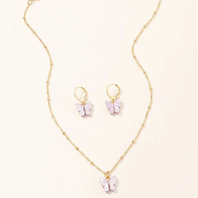 Gold chain necklace with lavender resin butterfly pendant and matching gold hoop earrings in creative fashion resin set