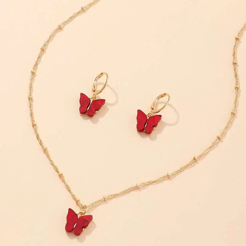 Fashion resin butterfly necklace and earring set with red resin butterfly pendant and matching gold hoop earrings