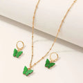 Fashion resin butterfly necklace set with green pendant and matching gold hoop earrings for creative fashion style