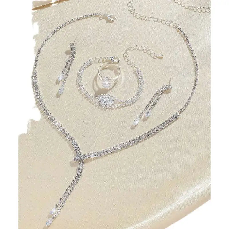 Silver rhinestone necklace with delicate chain links and clear crystal drop design from necklace earring bracelet set