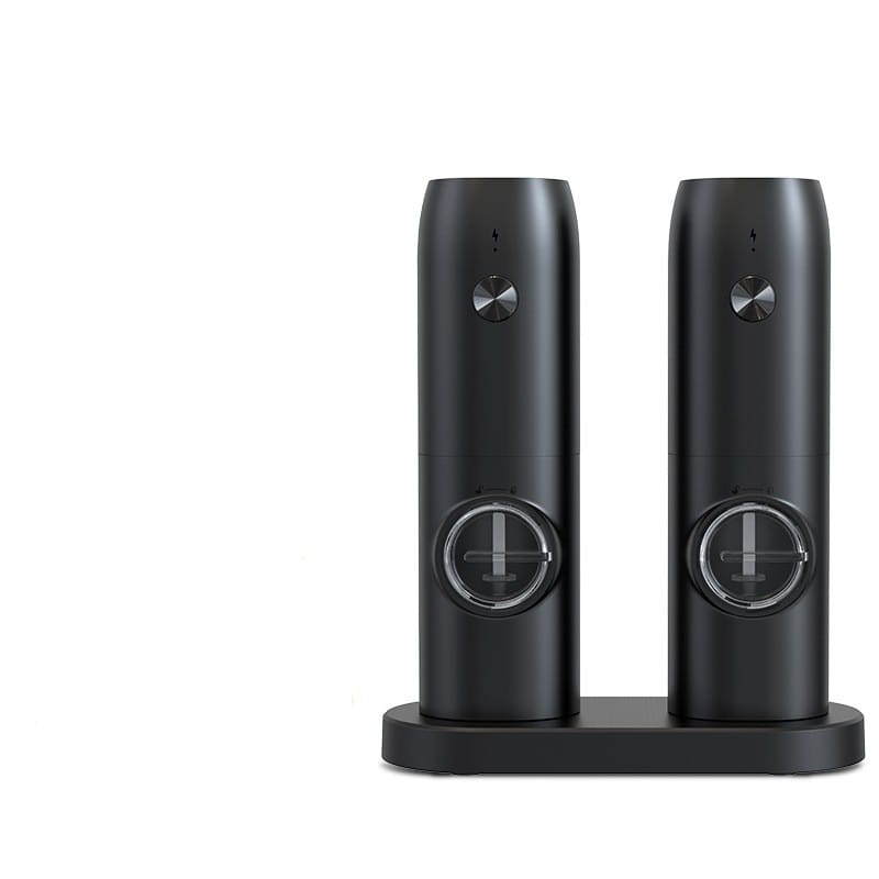 Two sleek black cylindrical wireless charging stands with metallic circular accents and minimalist design for electric kitchen household use in a kitchen household grinder set.