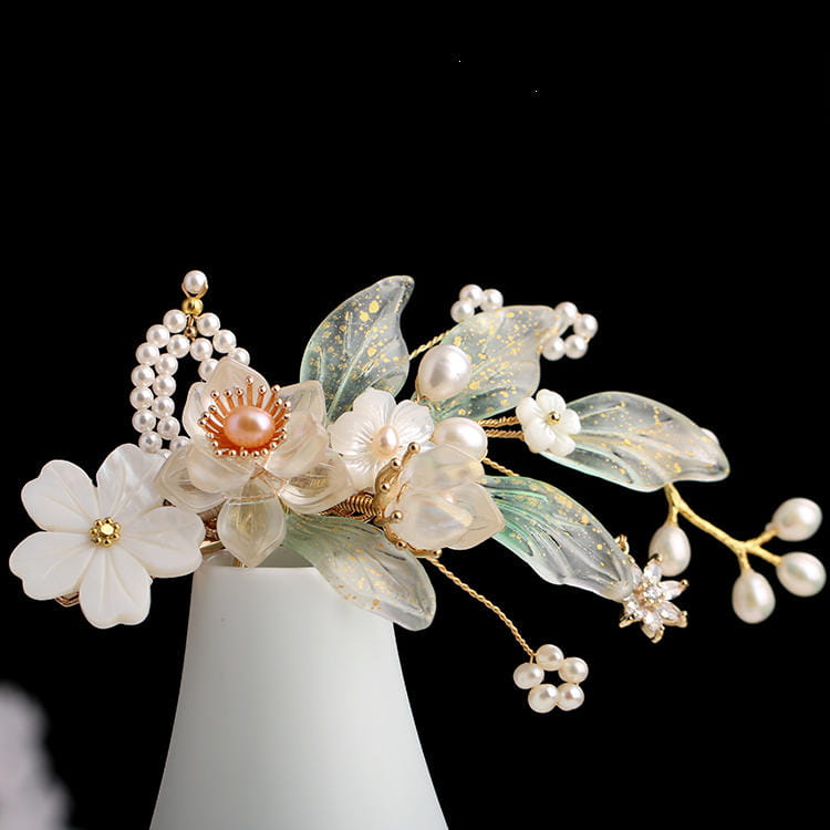 Elegant hanfu ancient style handmade fringed floral hair crown featuring translucent white and green petals, pearl accents, gold-toned details, and a central peach-colored gemstone.