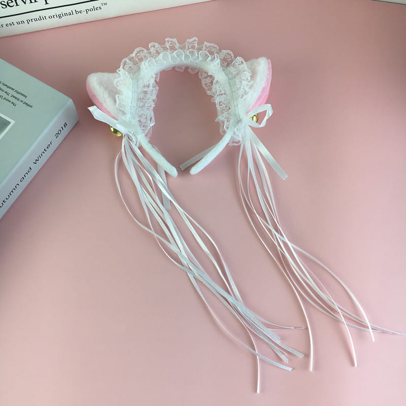 Japanese girl cute pink and white cat ear headband features lace trim, gold bells, and flowing ribbons with plush material for a girl cute bells plush accessory.