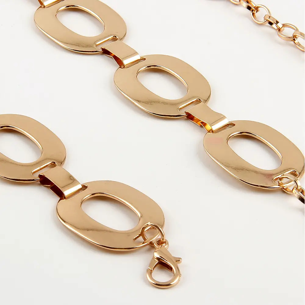 Gold-toned polished metallic oval link jewelry waist chain with lobster clasp designed as a summer jewelry waist accessory.
