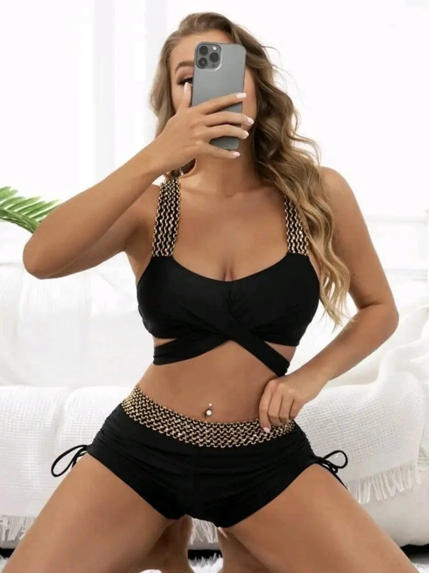 Black high waist bikini featuring gold chain detailing on the straps and waistband in a solid color high waist design.