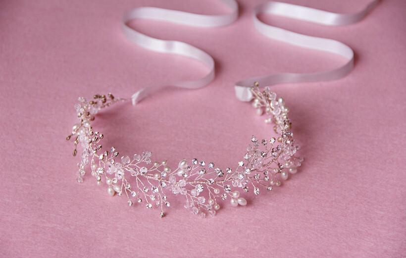 Silver crystal bridal hair accessory featuring a delicate silver-toned floral design with sparkling crystals and tiny pearls for elegant wedding styling.