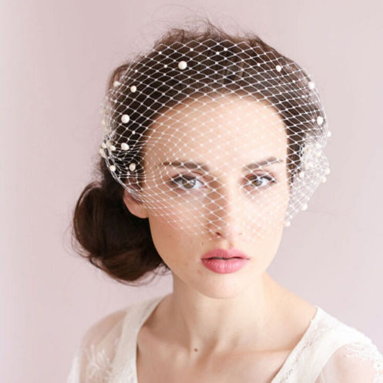 A delicate white bridal veil pearl hair comb featuring a large hole mesh design adorned with small pearl-like beads along its edges.