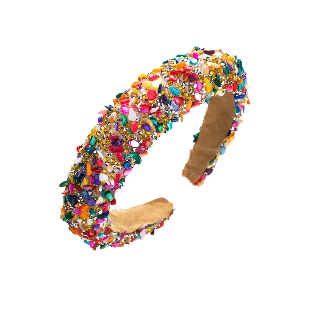 A baroque colorful headband featuring a vibrant open-ended design adorned with multicolored faceted gemstones and crystals in pink, green, gold, blue, orange, and white.