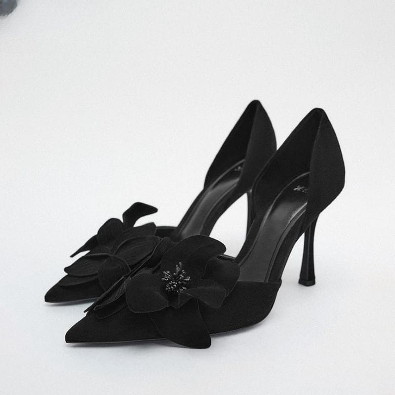 Black suede flower high heels with a pointed toe beautiful design and layered floral embellishments in magenta.