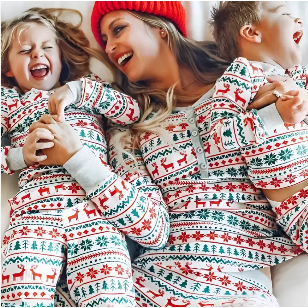 Festive family matching red green and white reindeer pajamas with snowflake patterns for cozy holiday wear