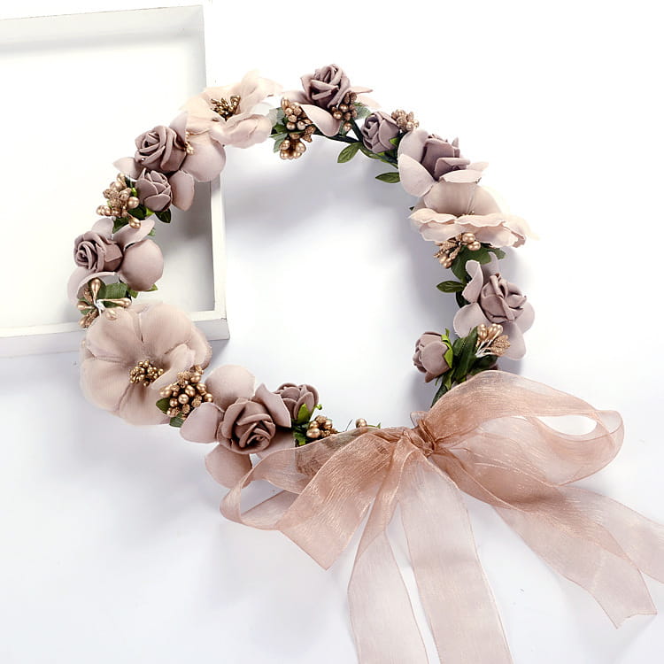 Blush rose wedding garland flower crown featuring a delicate mauve floral headband with soft fabric roses, green leaves, tiny gold beads, and a matching sheer ribbon bow.