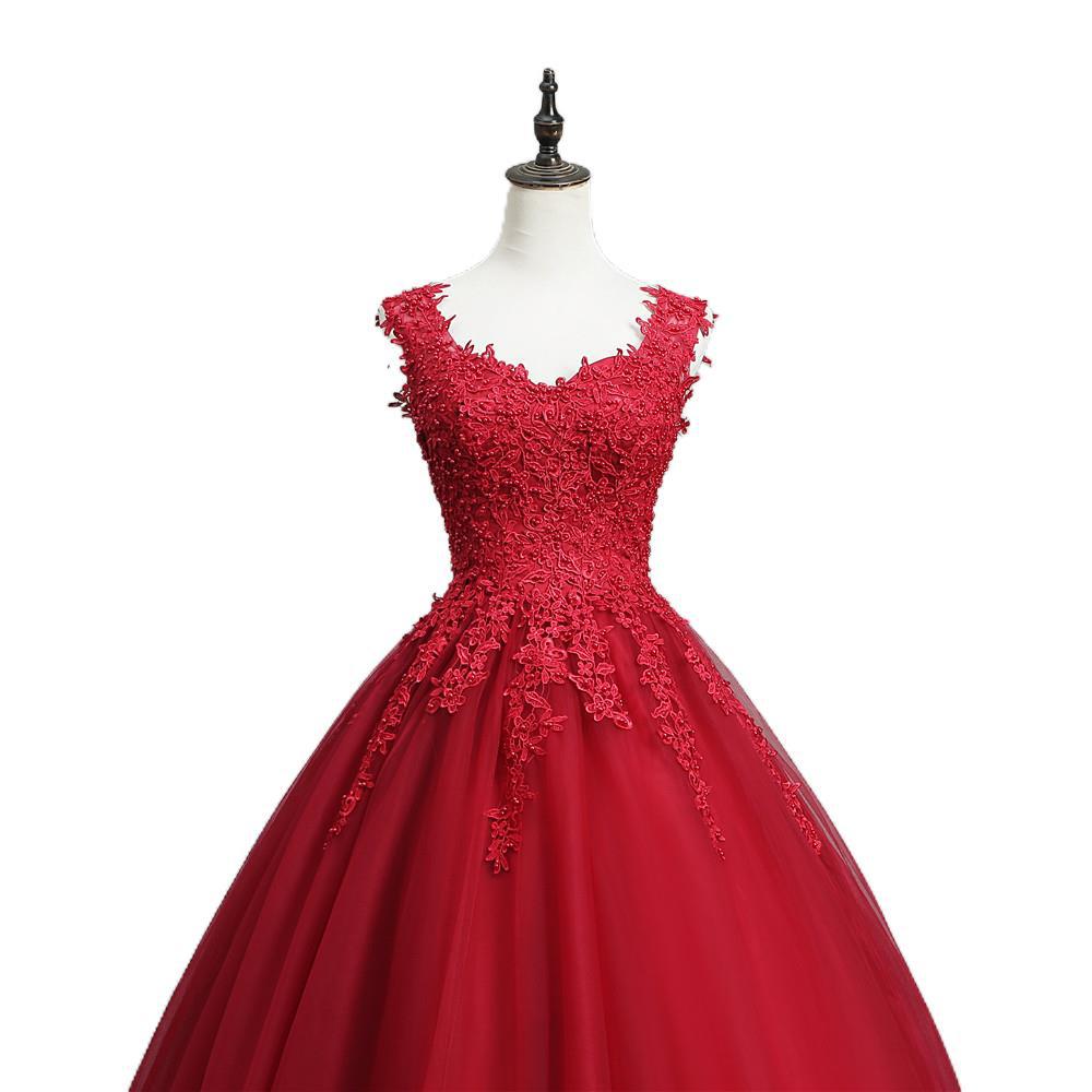 Elegant red lace bride princess dream gown featuring a fitted bodice and flowing tulle skirt for a princess dream bud look.