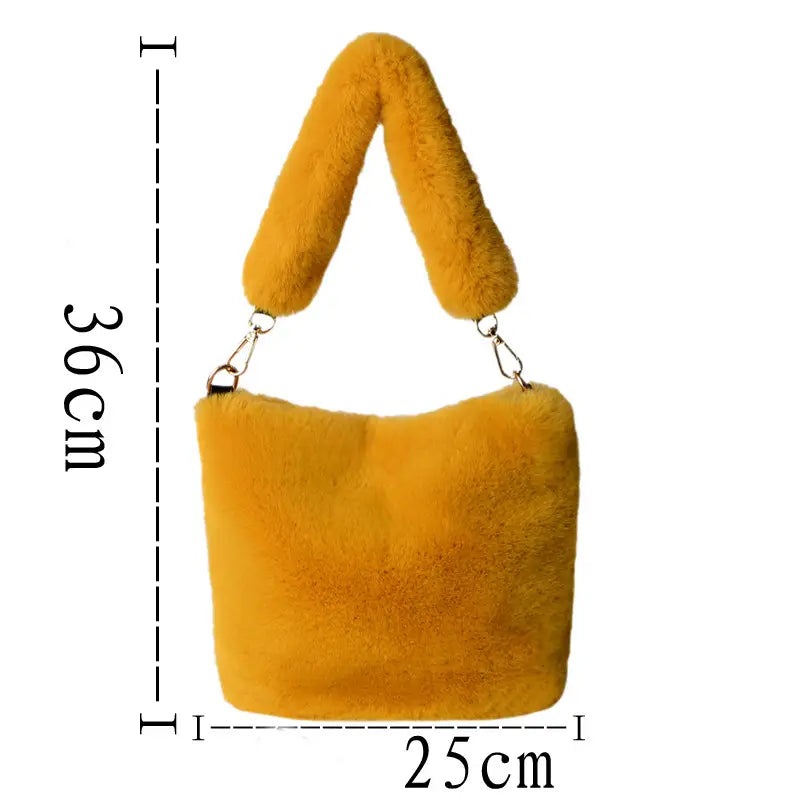 A plush mustard-yellow faux fur checkerboard plush bucket bag with a soft fluffy texture, matching handle, and pearl chain design.