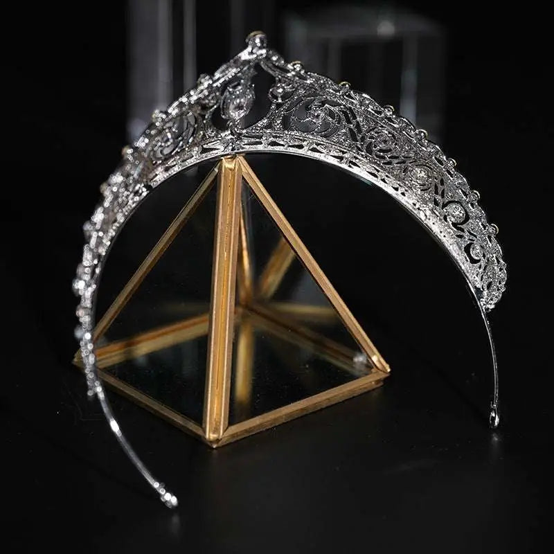 Silver filigree bridal crown with intricate lace detailing and sparkling crystals ideal for wedding makeup looks