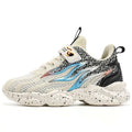 Cream-colored mesh boys sneakers with black speckles and a bold blue silver flame design with rose gold strap