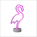 A glowing pink neon flamingo led modeling light night light with a sleek design and gray circular base decorative night light