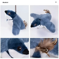 Blue plush flapping bird cat toy penguin keychain with soft blue and white fur, brown eyes, black beak, and decorative feathers