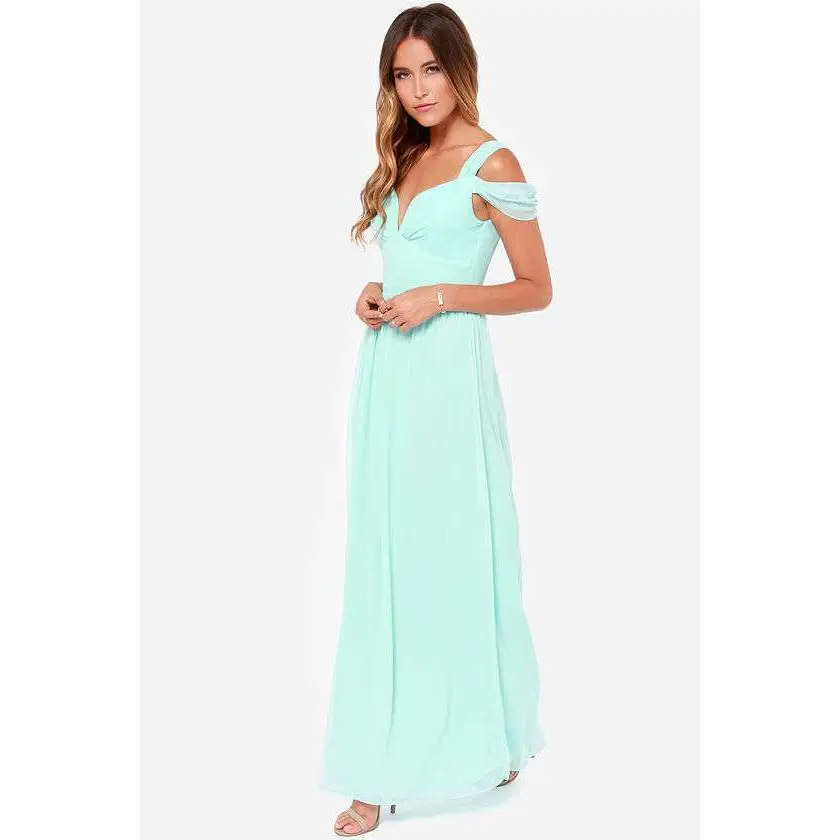 A flowing mint green chiffon floor length elegant greek style maxi dress with off the shoulder straps and sweetheart neckline