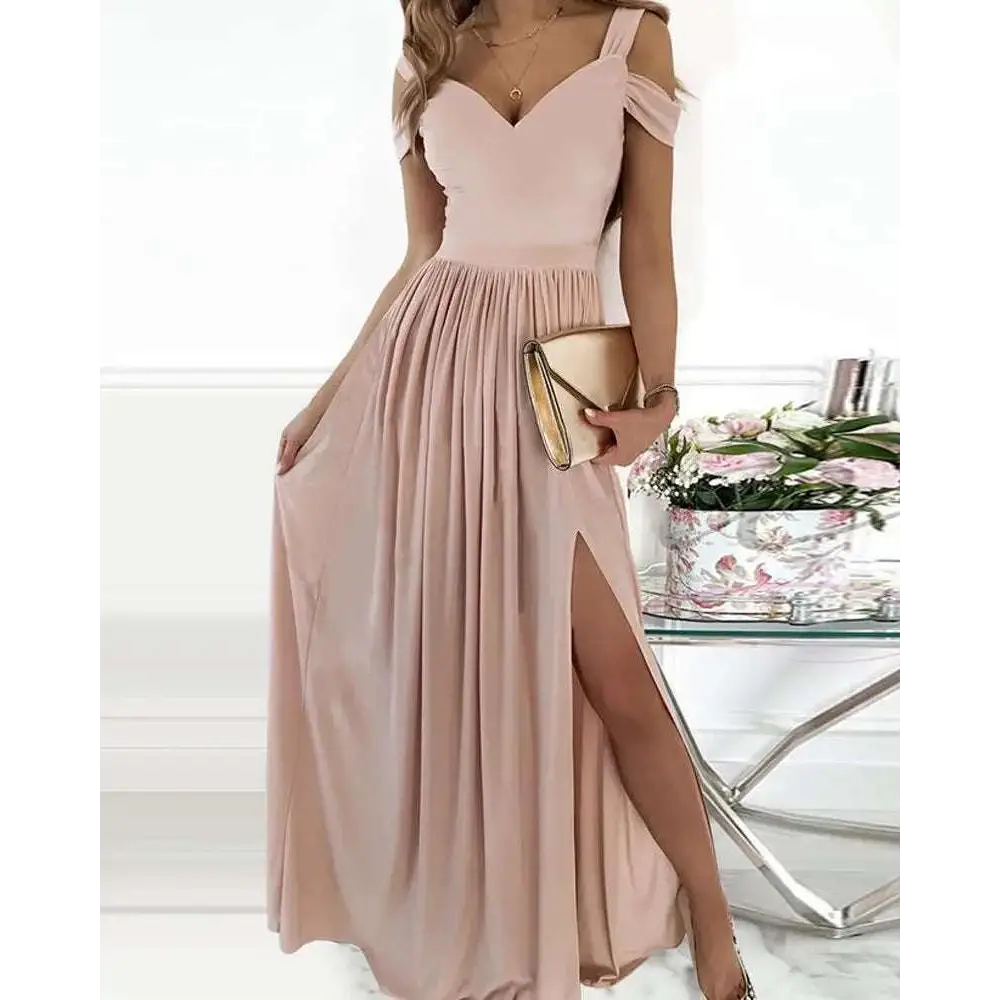 A soft blush pink elegant greek style maxi dress with off-the-shoulder fitted bodice and flowing pleated skirt