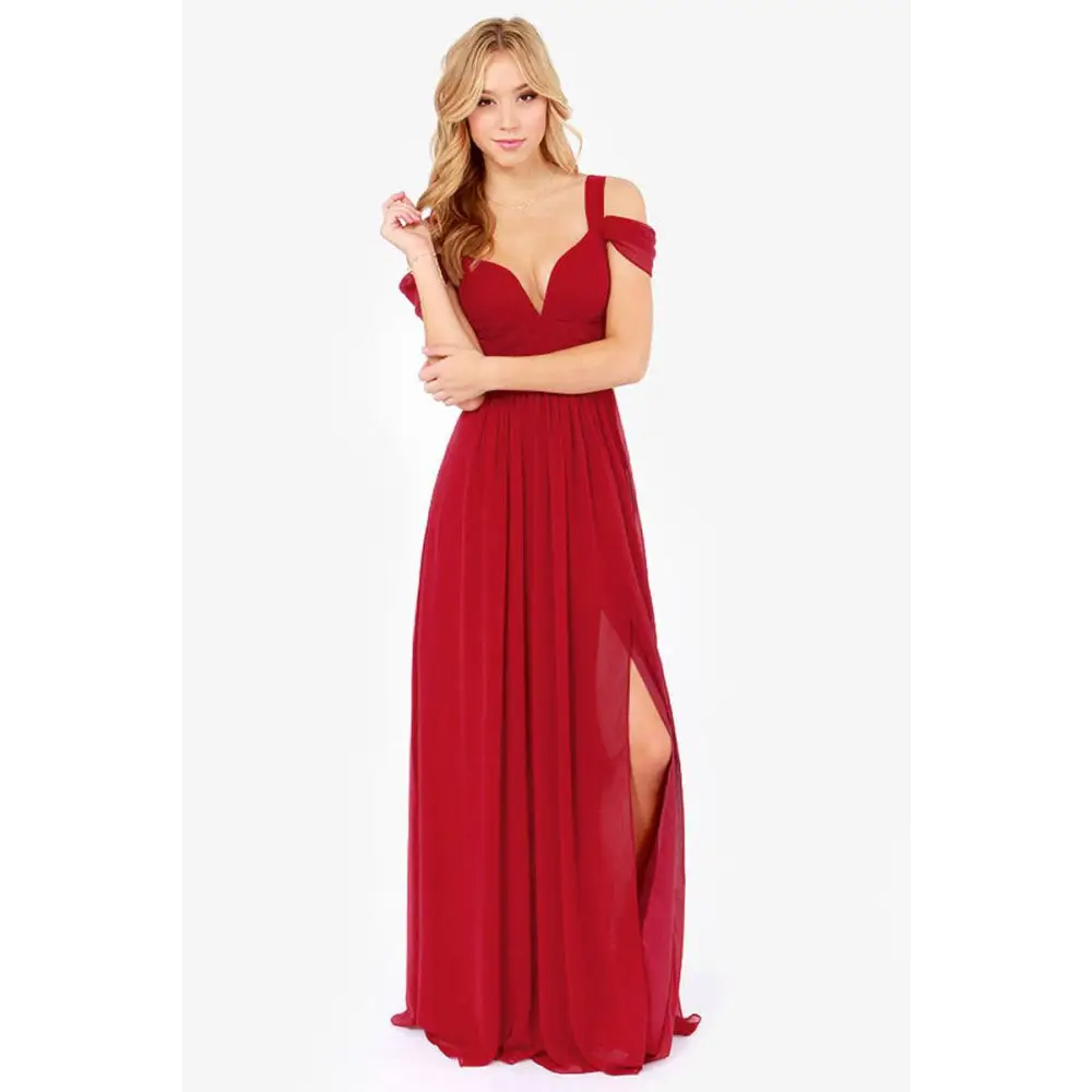 A flowing red elegant greek style maxi dress with off-the-shoulder deep v-neckline and sheer side slit